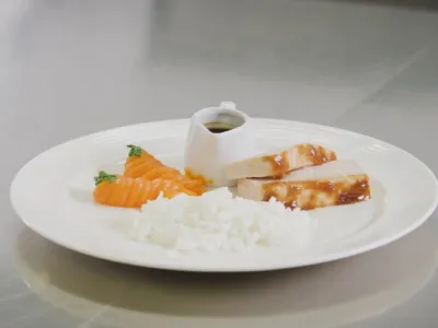 White plate with scattered orange fish-shaped crackers and crumbs