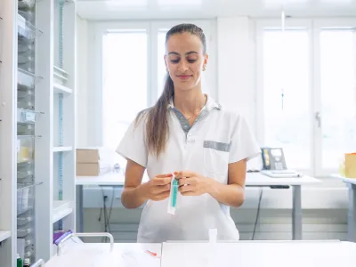 A woman in a lab coat working in a laboratory.