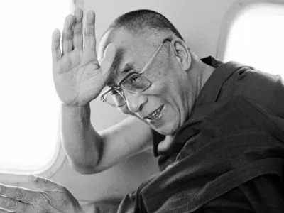 A contemplative dalai lama with eyes closed, displaying a serene expression.