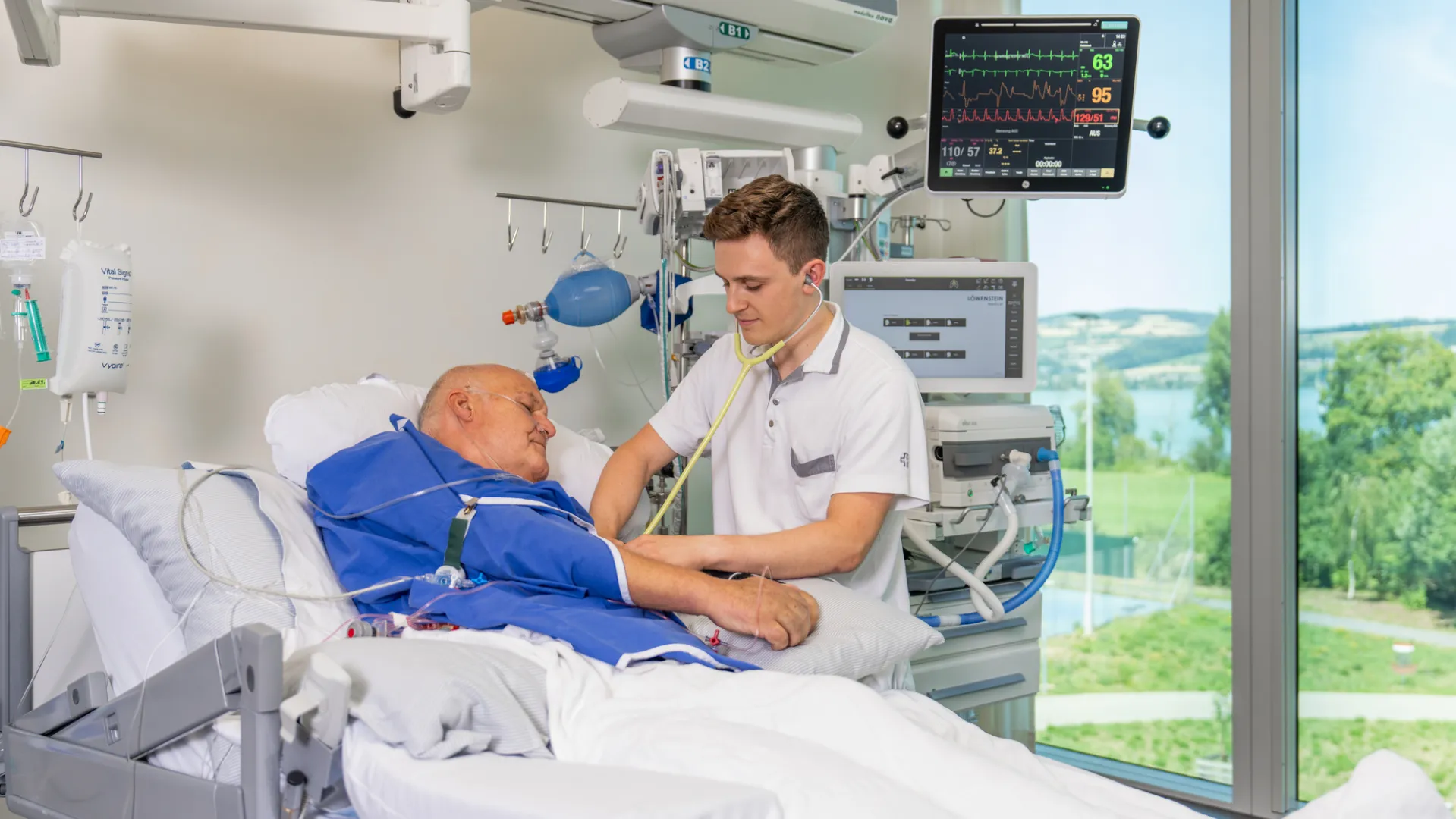 A medical professional examining a patient in a hospital room.