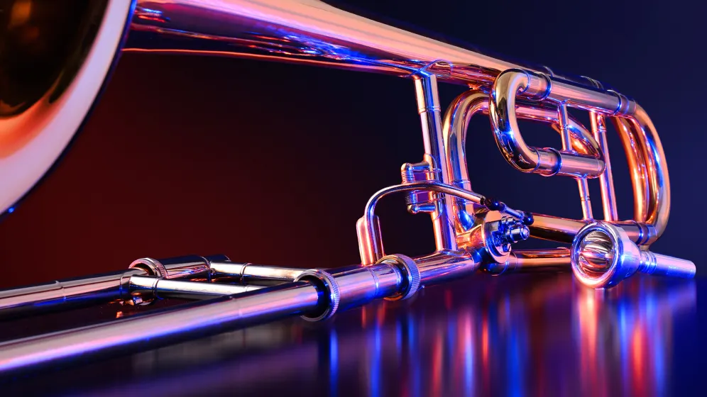A pair of neon trombone silhouettes on a reflective surface.