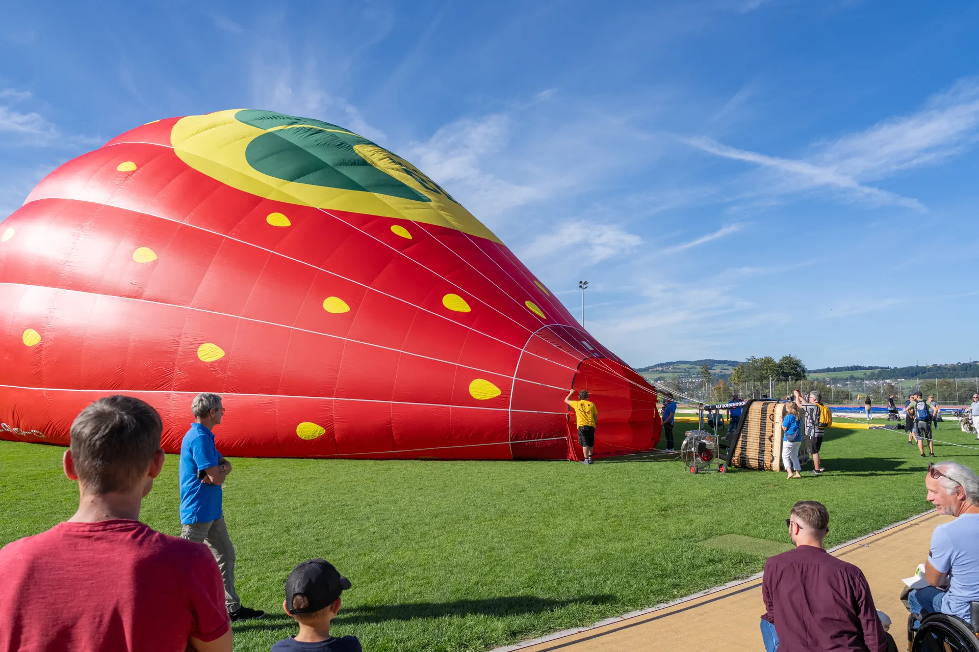 Ein Heissluftballon wird auf dem Sportplatz der Schweizer Paraplegiker-Gruppe aufgeblasen.