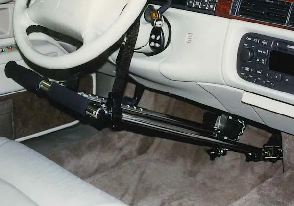 Black steering wheel lock device attached to car's steering wheel and pedal