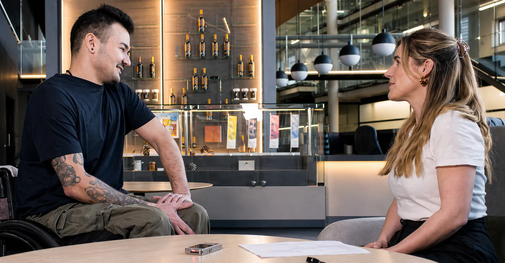 Researcher talking to a man in a wheelchair