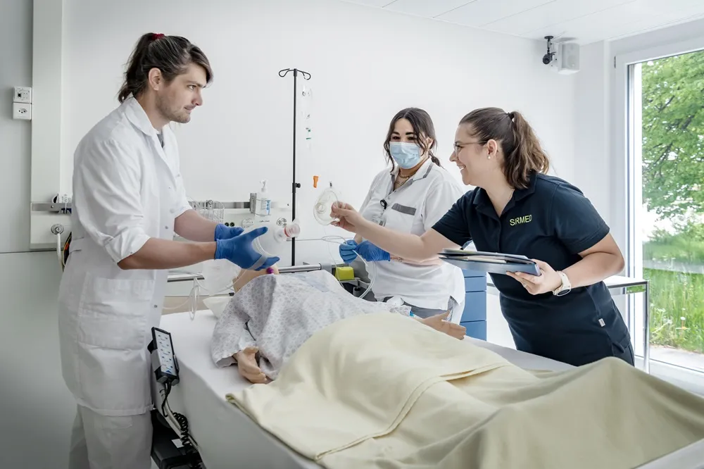 Medical team examining patient in hospital bed, nurse adjusting IV drip