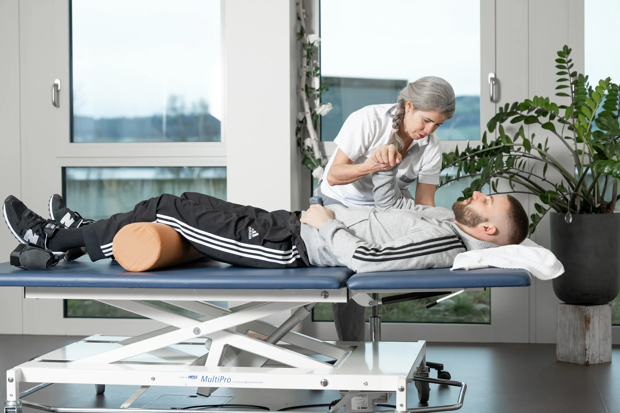 Two people lying on desks, relaxing.