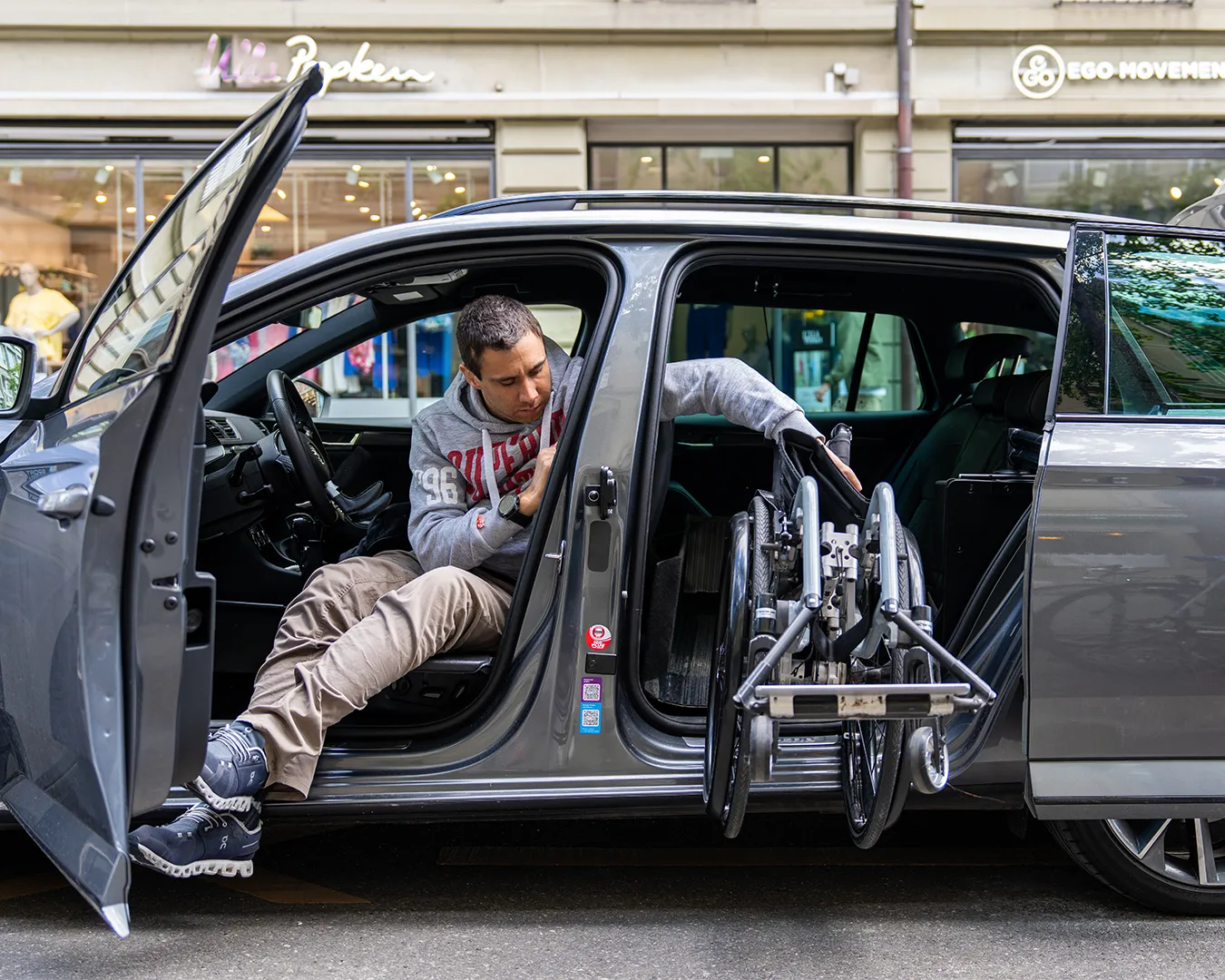 A man in a wheelchair exits a van through a side door.