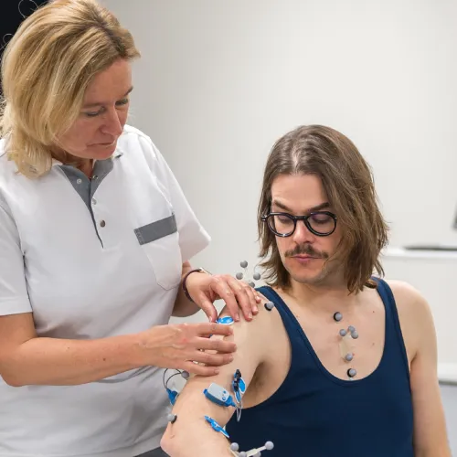 Healthcare provider examining patient's arm in medical office setting