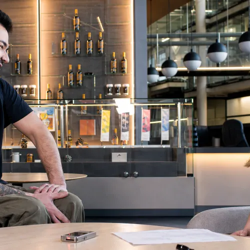 Une chercheuse en conversation avec un homme en fauteuil roulant