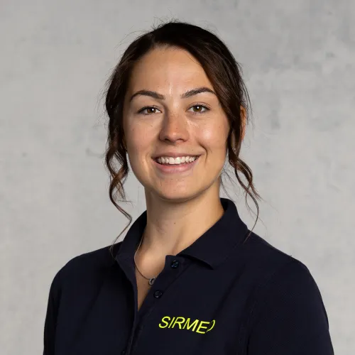 Smiling woman with dark hair and a green logo shirt